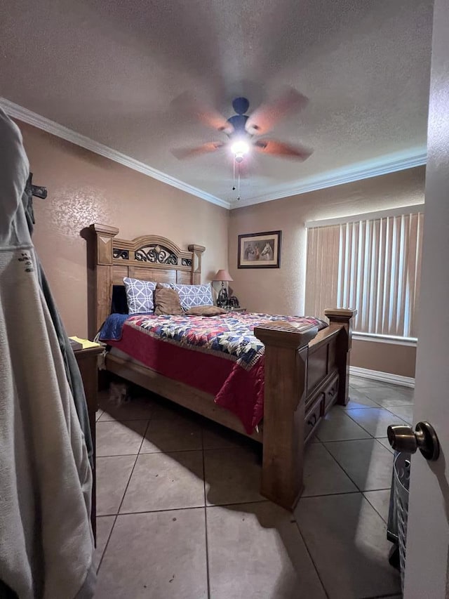 bedroom featuring ceiling fan, crown molding, a textured ceiling, and tile patterned floors