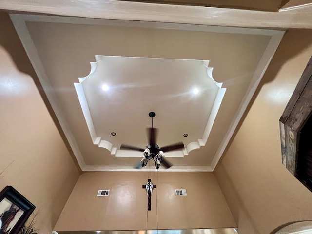 bathroom featuring ceiling fan, visible vents, and crown molding