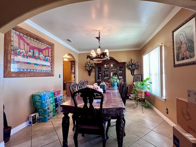 dining space featuring light tile patterned floors, visible vents, arched walkways, ornamental molding, and a notable chandelier