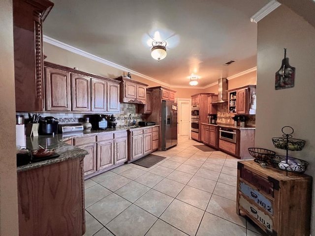 kitchen featuring stainless steel appliances, ornamental molding, wall chimney exhaust hood, and light tile patterned floors