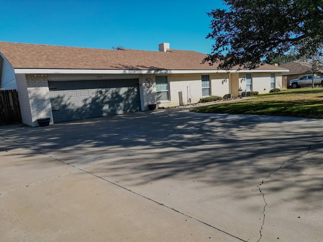 ranch-style home featuring a garage and a front yard