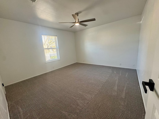 carpeted empty room with a textured ceiling and ceiling fan