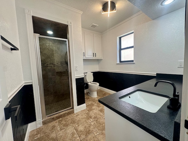 bathroom with toilet, an enclosed shower, crown molding, a textured ceiling, and vanity