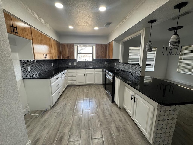 kitchen featuring tasteful backsplash, decorative light fixtures, dishwasher, kitchen peninsula, and white cabinets