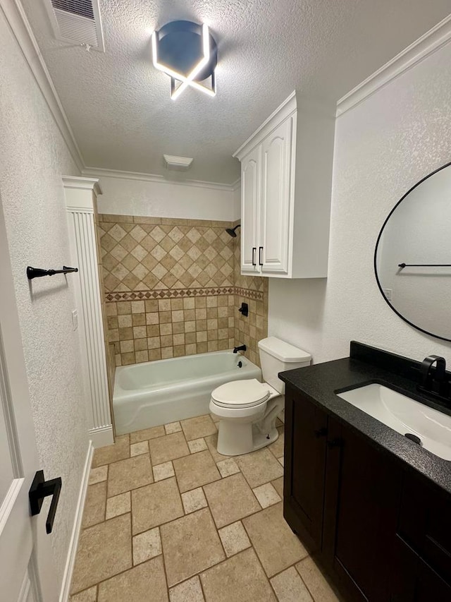 full bathroom with toilet, crown molding, tiled shower / bath, a textured ceiling, and vanity