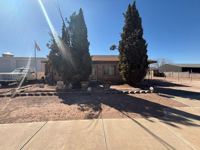 view of front of property featuring a carport and brick siding