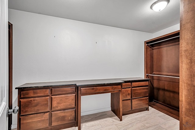 walk in closet featuring built in desk