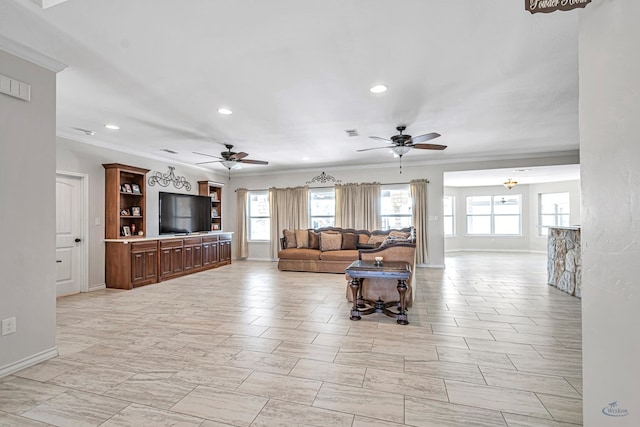 living room with ceiling fan and ornamental molding