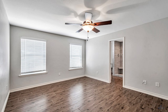 unfurnished room with a textured ceiling, a wealth of natural light, and dark hardwood / wood-style floors