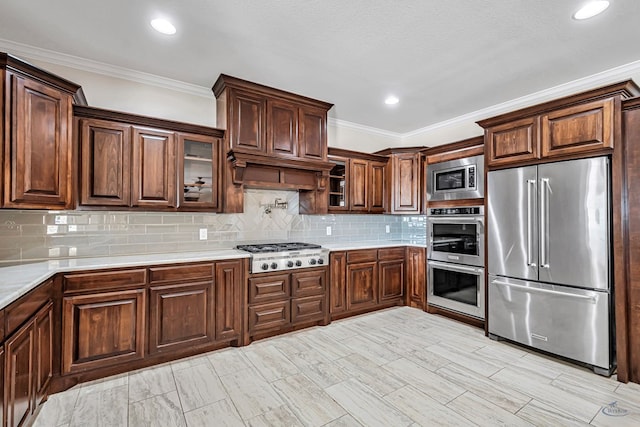 kitchen with backsplash, crown molding, custom exhaust hood, and appliances with stainless steel finishes