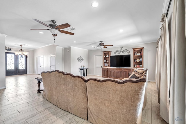 living room featuring french doors, ceiling fan with notable chandelier, light hardwood / wood-style floors, and crown molding