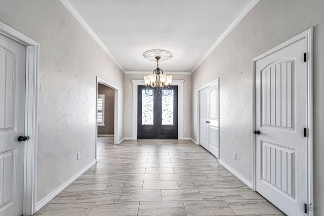 foyer entrance with french doors, a chandelier, and ornamental molding