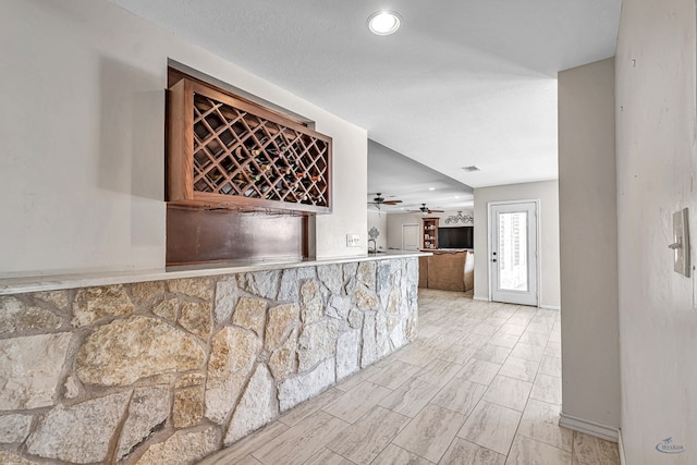 kitchen featuring ceiling fan and a textured ceiling