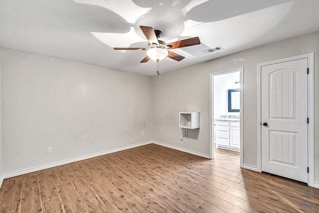 unfurnished room with ceiling fan and wood-type flooring