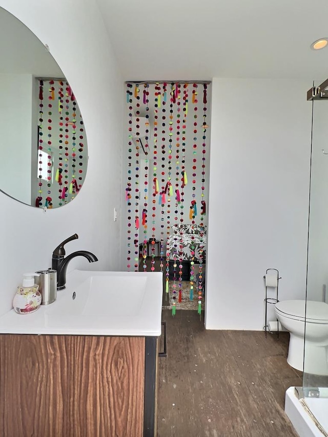 bathroom featuring hardwood / wood-style flooring, vanity, and toilet