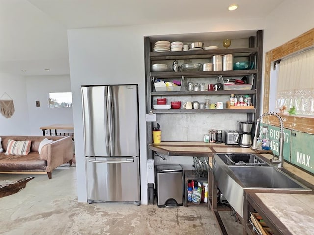 kitchen featuring stainless steel refrigerator and sink