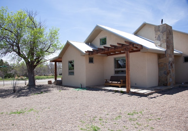 view of side of home with a patio and stucco siding