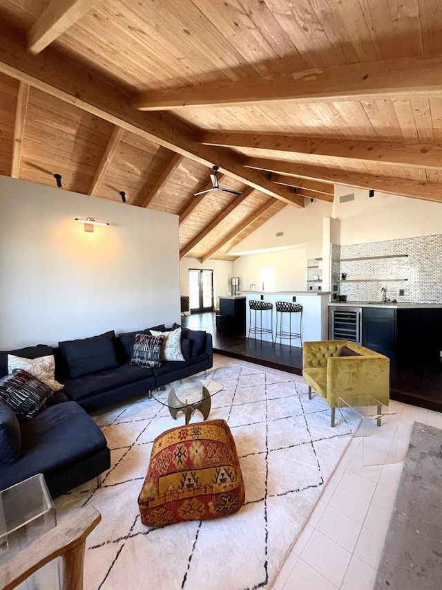 living area featuring beverage cooler, light tile patterned floors, wood ceiling, and lofted ceiling with beams