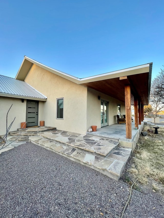 back of property featuring a patio and stucco siding