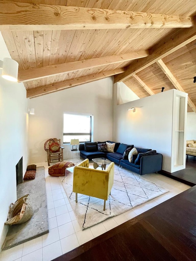 living area featuring a fireplace, lofted ceiling with beams, wood ceiling, and tile patterned floors