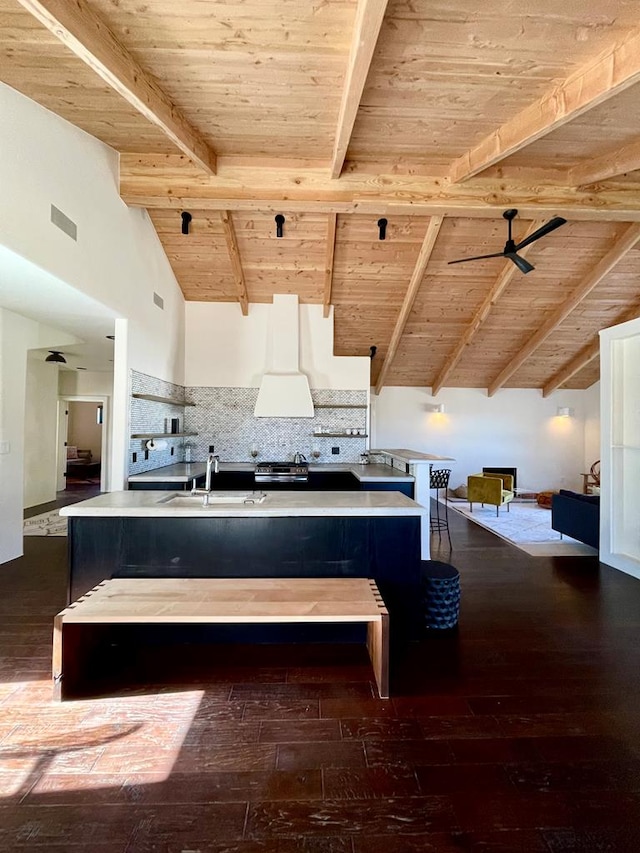 kitchen featuring ceiling fan, wooden ceiling, dark wood finished floors, and a sink