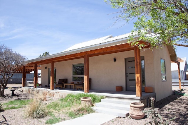 exterior space featuring covered porch and stucco siding