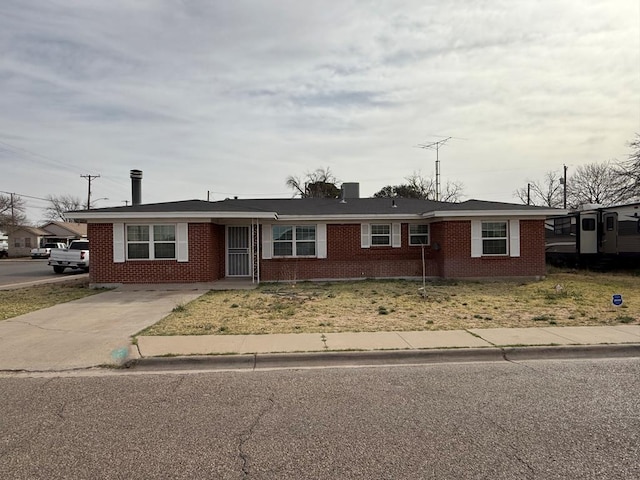 ranch-style house featuring brick siding