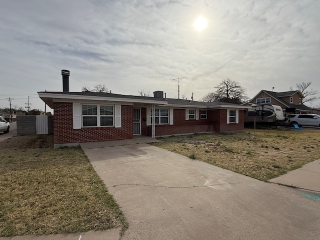 ranch-style home with fence, a front lawn, and brick siding