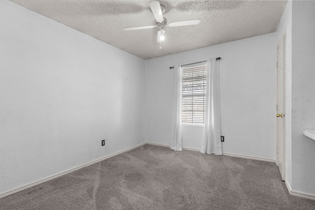 empty room with light colored carpet, a textured wall, a ceiling fan, a textured ceiling, and baseboards