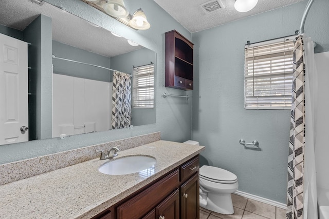 full bath with visible vents, toilet, vanity, a textured ceiling, and tile patterned flooring