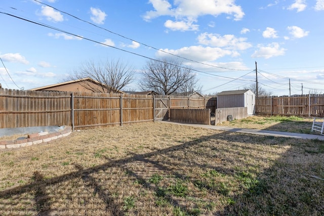 view of yard featuring a fenced backyard, a storage unit, and an outdoor structure