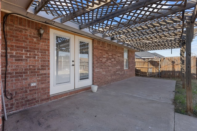 view of patio with french doors, fence, and a pergola