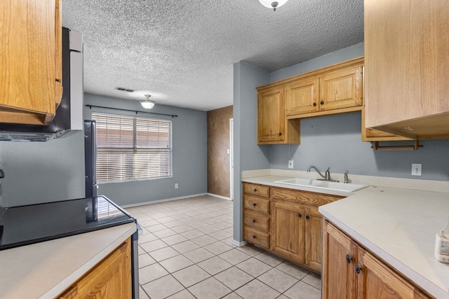 kitchen with light tile patterned floors, light countertops, visible vents, a sink, and a textured ceiling