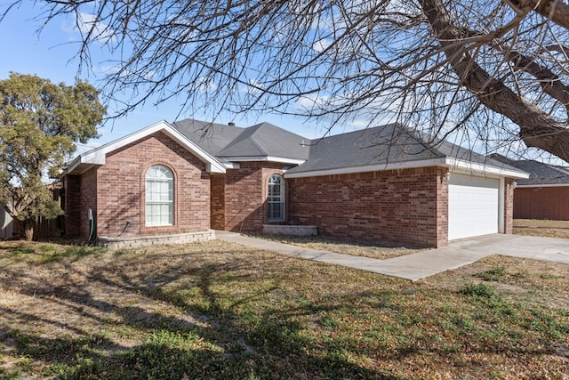 single story home featuring a garage, concrete driveway, brick siding, and a front lawn