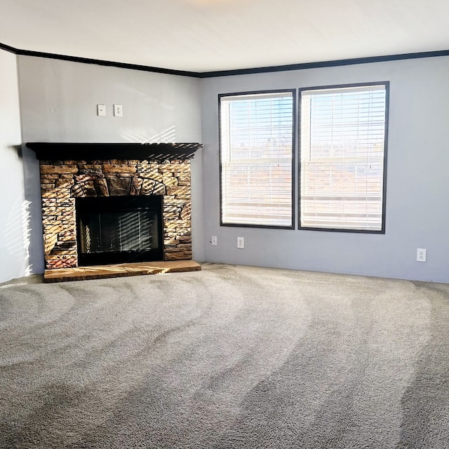 unfurnished living room with crown molding, a fireplace, and carpet