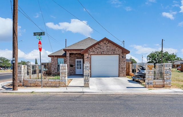 view of front facade featuring a fenced front yard, brick siding, a shingled roof, and a garage