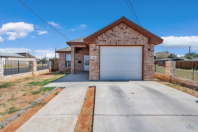 view of front facade with concrete driveway, brick siding, and fence