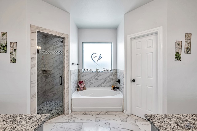 bathroom with marble finish floor, a shower stall, a textured ceiling, and a bath