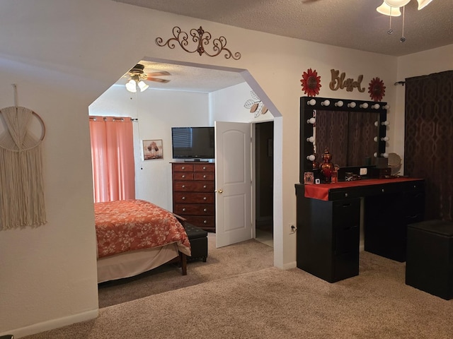 bedroom with a textured ceiling, a ceiling fan, and carpet floors