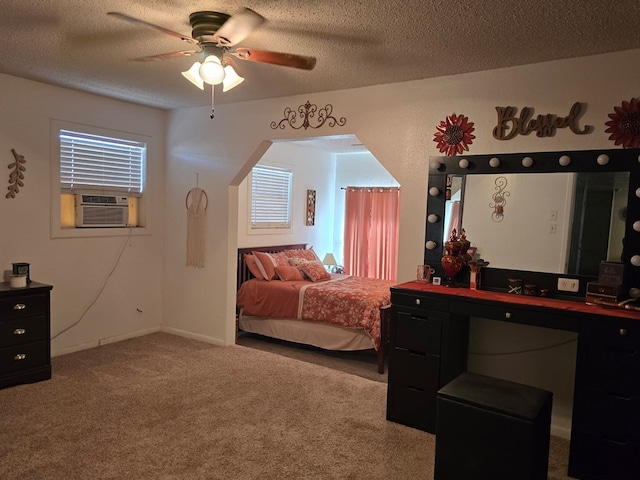 carpeted bedroom with cooling unit, a ceiling fan, baseboards, and a textured ceiling