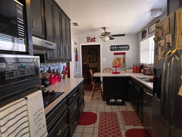 kitchen with light tile patterned floors, a ceiling fan, visible vents, black appliances, and light countertops