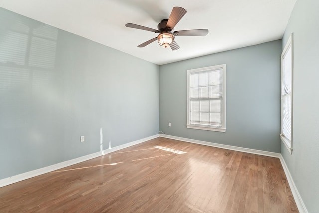 spare room with ceiling fan and hardwood / wood-style flooring