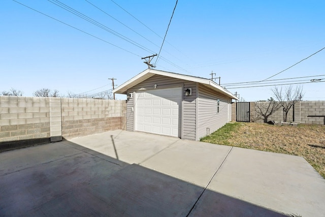 view of side of home featuring a garage and an outdoor structure