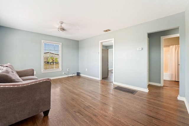 sitting room featuring dark hardwood / wood-style floors and ceiling fan