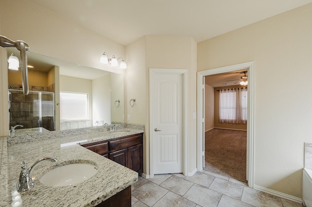 full bath featuring a stall shower, a wealth of natural light, and a sink