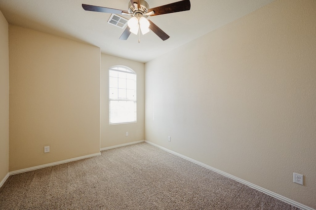 empty room with ceiling fan, baseboards, visible vents, and light colored carpet