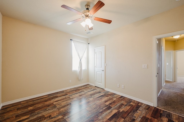 unfurnished room featuring ceiling fan, wood finished floors, visible vents, and baseboards