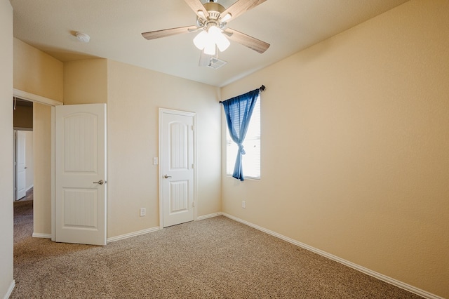 unfurnished bedroom featuring ceiling fan, carpet flooring, visible vents, and baseboards