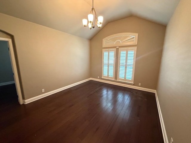 unfurnished room with an inviting chandelier, baseboards, vaulted ceiling, and dark wood-style flooring