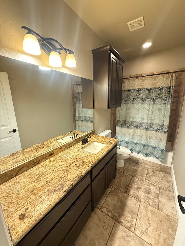 full bath with shower / bath combo, visible vents, toilet, stone finish flooring, and vanity